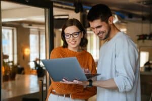 Zwei Personen machen einen Kontrollgang mit einen Laptop in der Hand