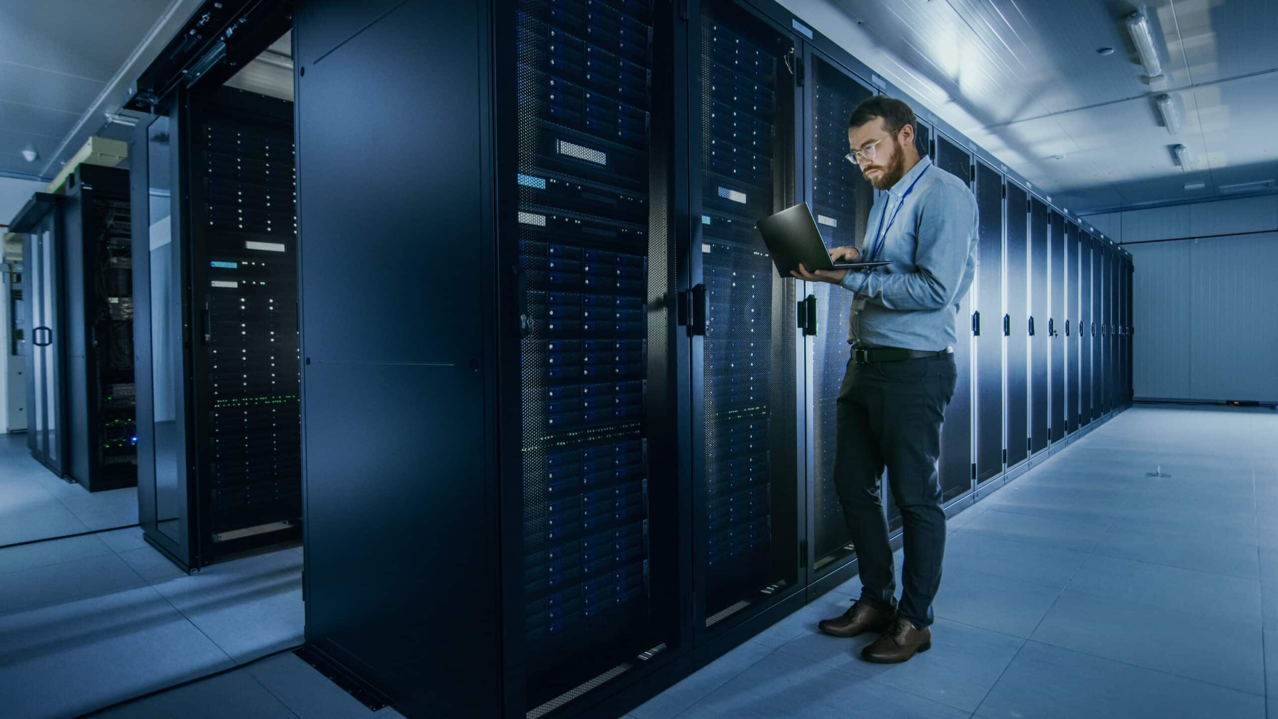 A person is standing in a server room