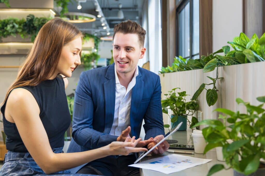 Two people sitting in a green office